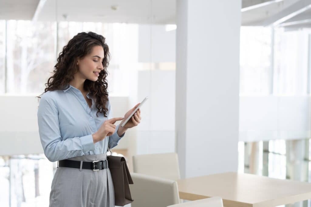 Young elegant female chief executive officer of modern high tech company