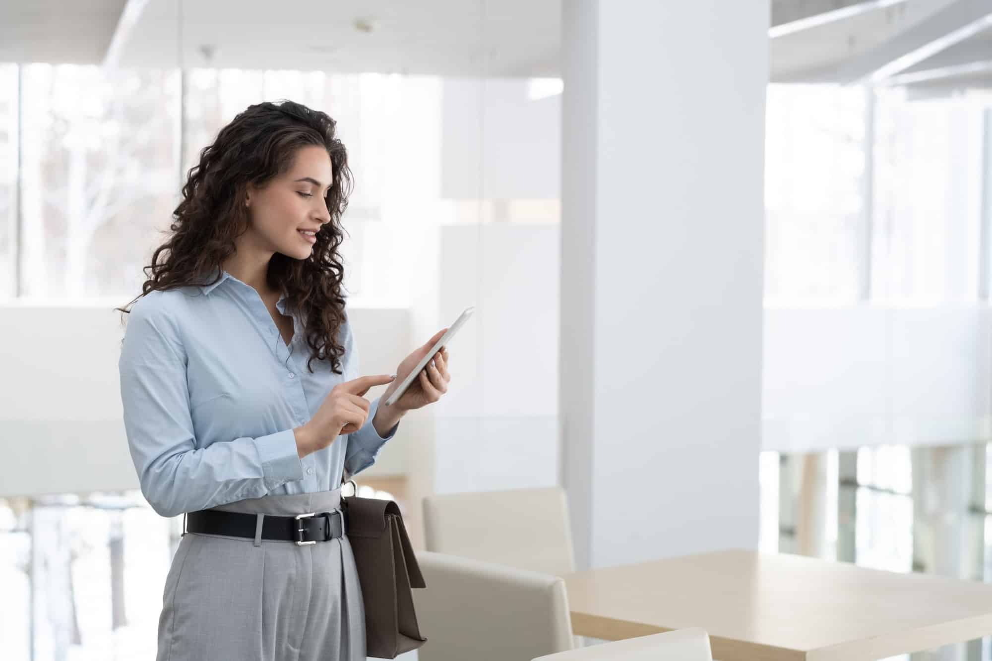 Young elegant female chief executive officer of modern high tech company